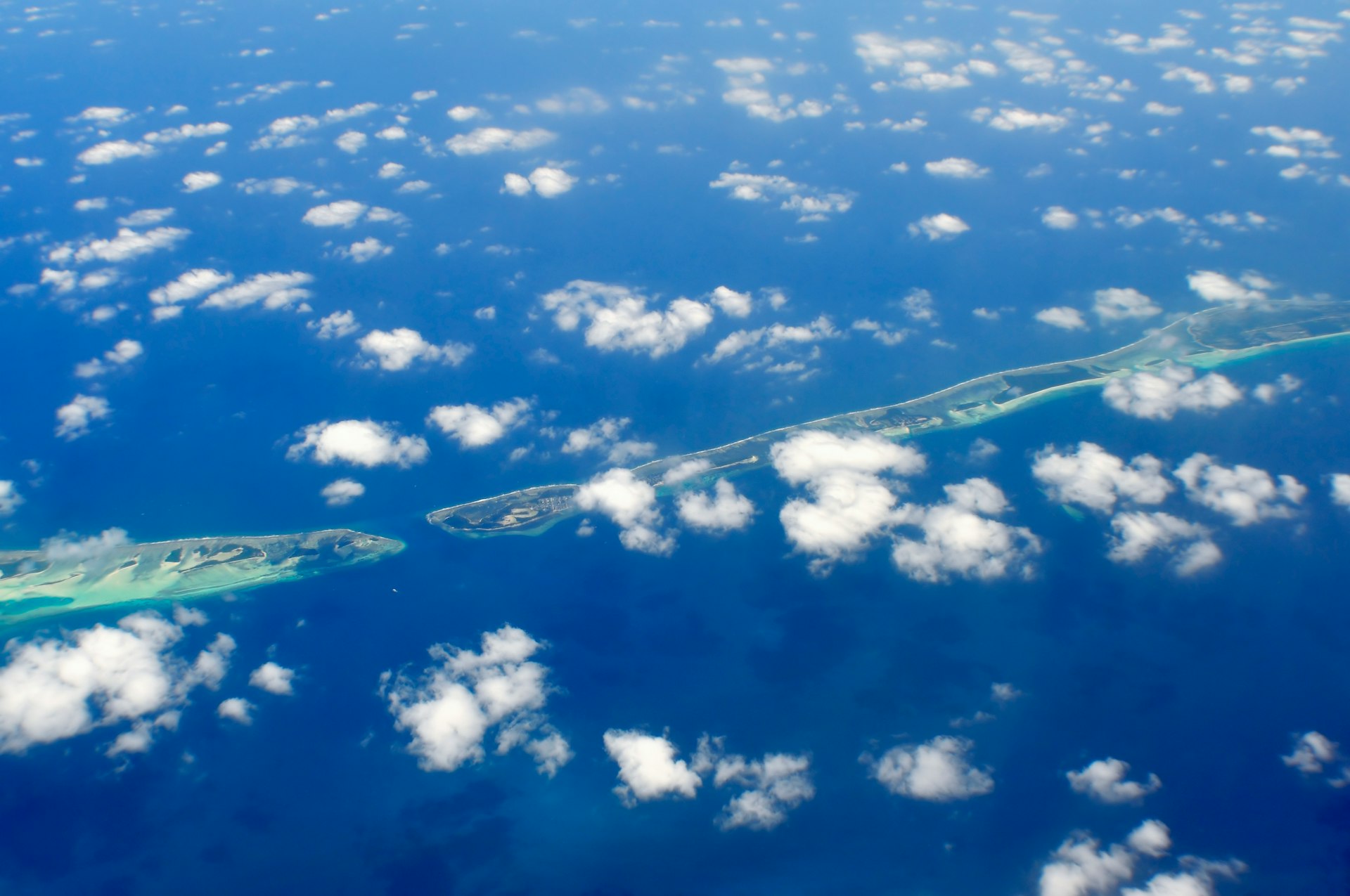 aerial photography of green island and clouds